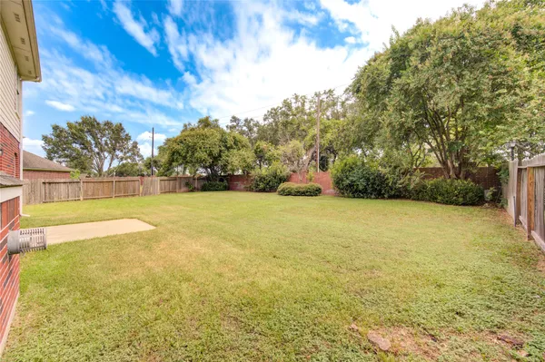 a view of yard with swimming pool and green space