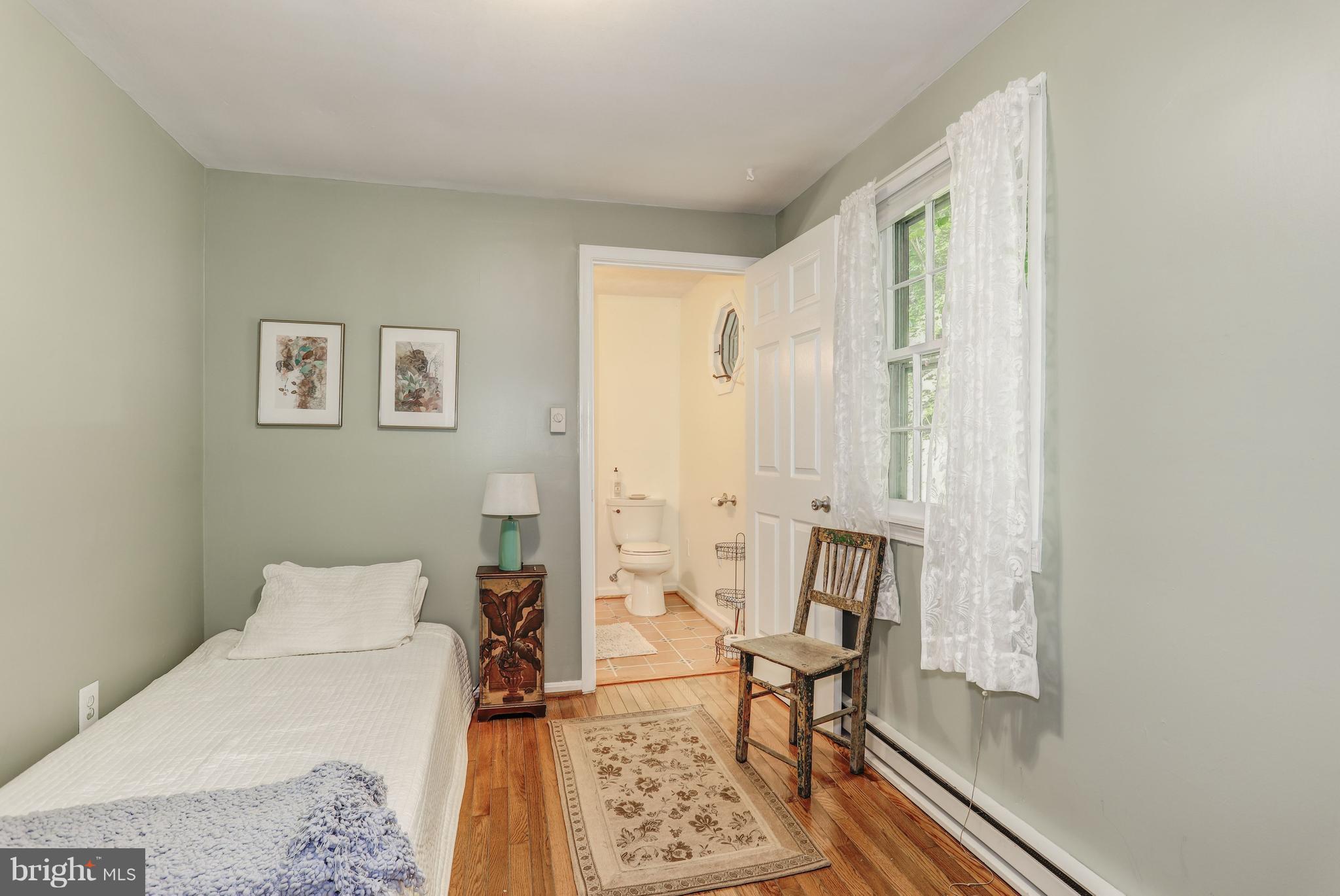 7137 Wilson Road Marshall, VA 20115 - Photo 14 of 24 a bedroom with a bed and wooden floor