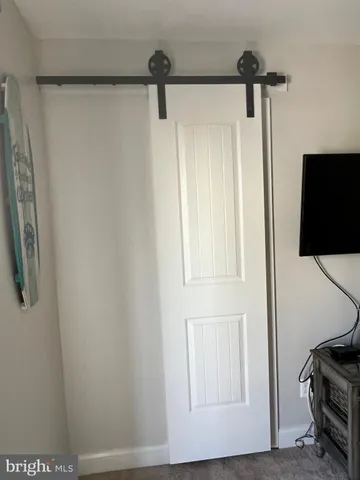 a utility room with a sink and wooden floor
