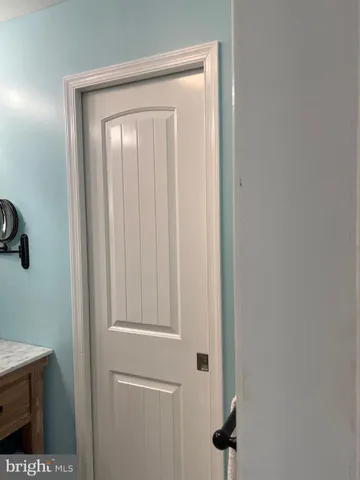 a bathroom with a glass shower door