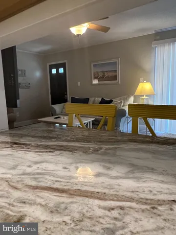 a living room with furniture and a lamp