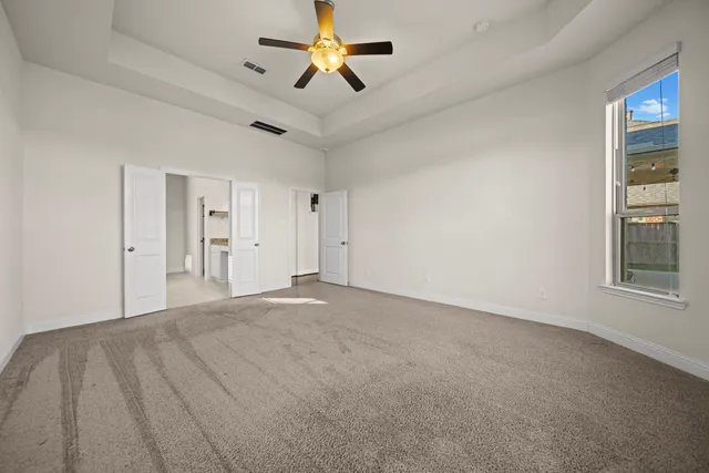 a view of empty room with ceiling fan
