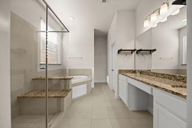 a bathroom with a granite countertop sink a toilet and bathtub