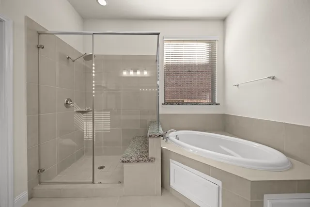 a white bath tub sitting next to a shower