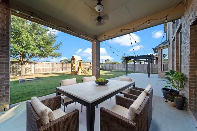 a view of an outdoor dining space with a table and chairs