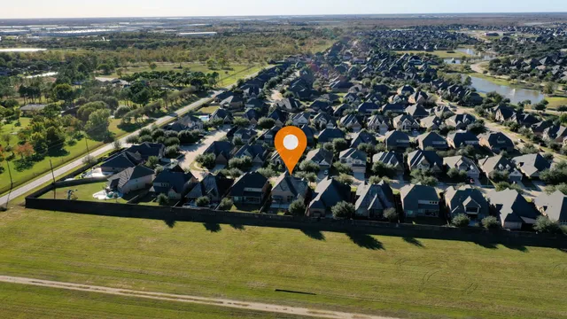 an aerial view of residential houses with outdoor space