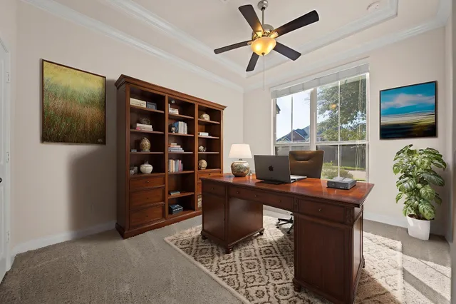 a work room with furniture and a bookshelf