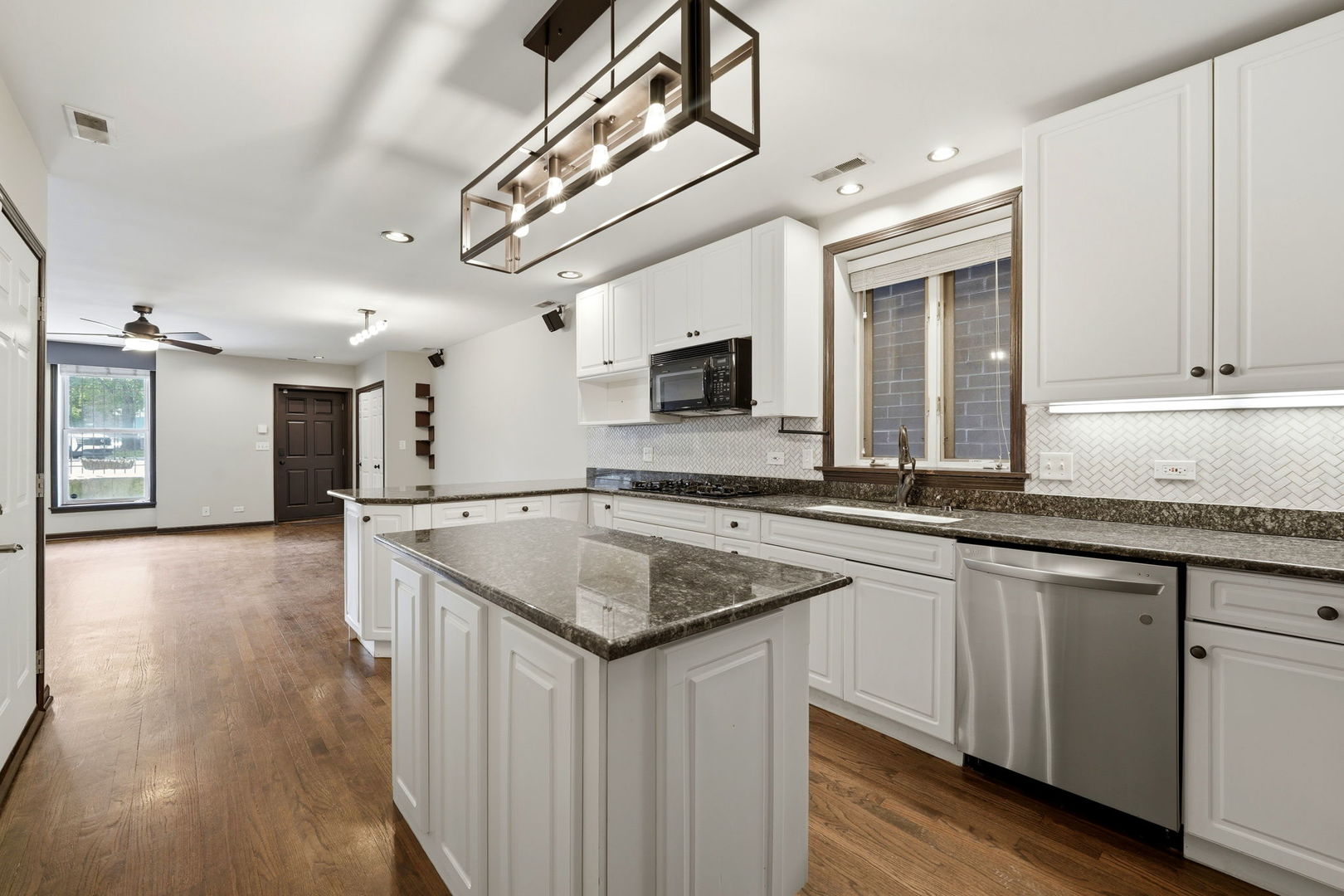 619 North Racine Avenue, Unit 1 Chicago, IL 60642 - Photo 17 of 36 a kitchen with a sink and cabinets