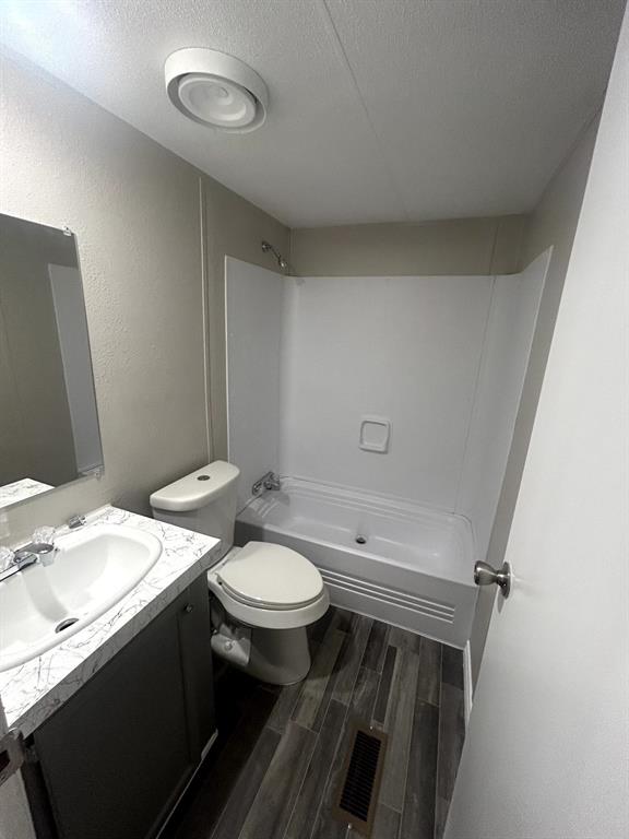 717 Byron Road Wilmer, TX 75172 - Photo 9 of 20 Contemporary bathroom featuring a dark wood-finish vanity with a white countertop and integrated sink