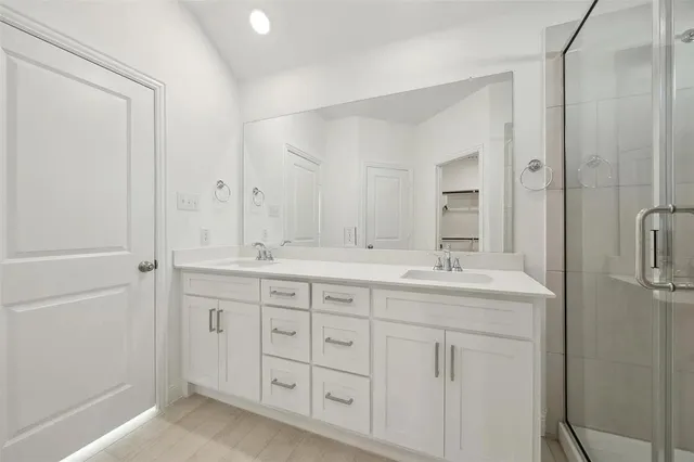 a bathroom with double sink and a mirror