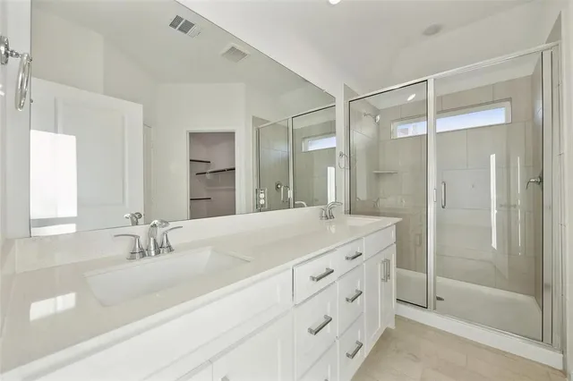 a bathroom with a granite countertop sink mirror and double