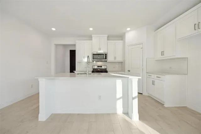 a kitchen with stainless steel appliances cabinets a sink and a stove