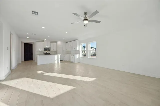 a view of a kitchen with a sink stainless steel appliances and cabinets