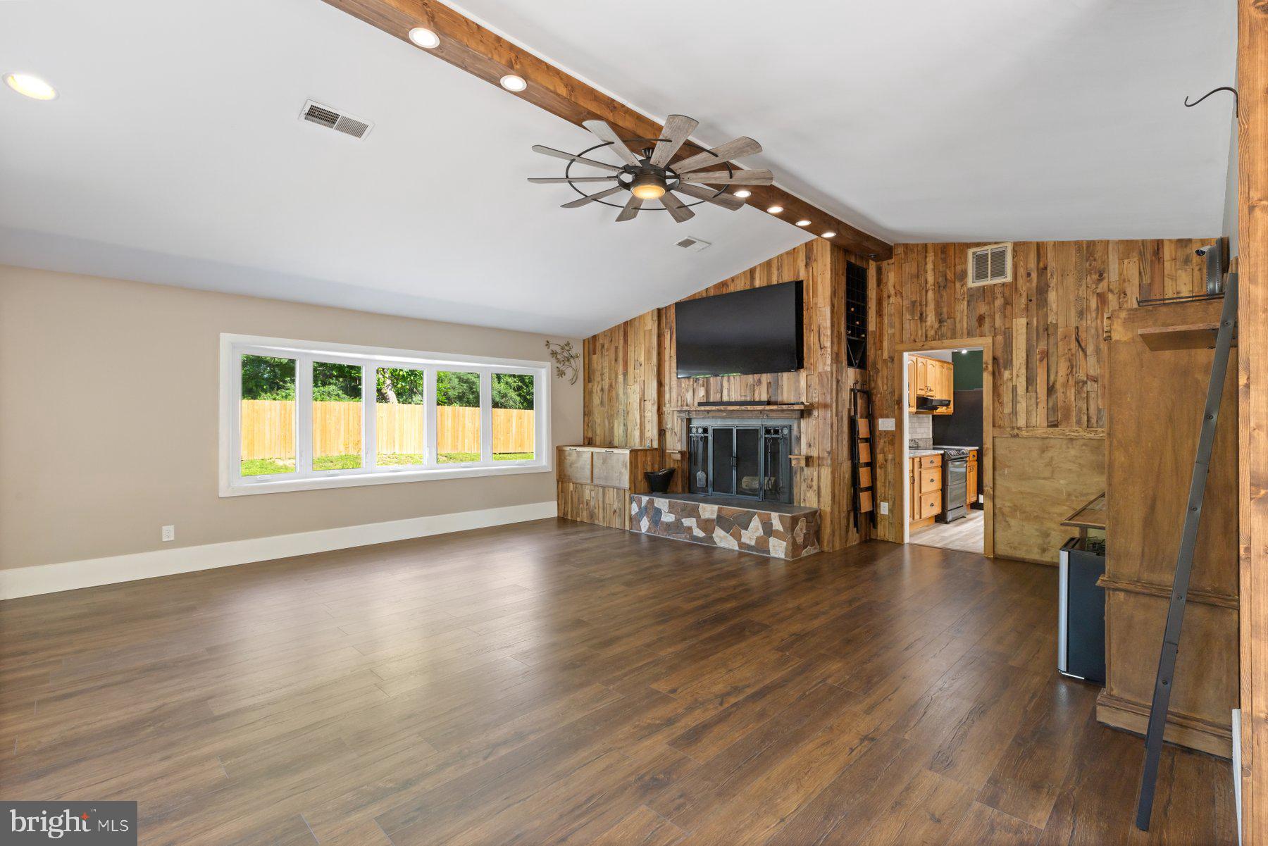 13033 Bottom Road Hydes, MD 21082 - Photo 12 of 45 a view of an empty room with wooden floor fireplace and a window