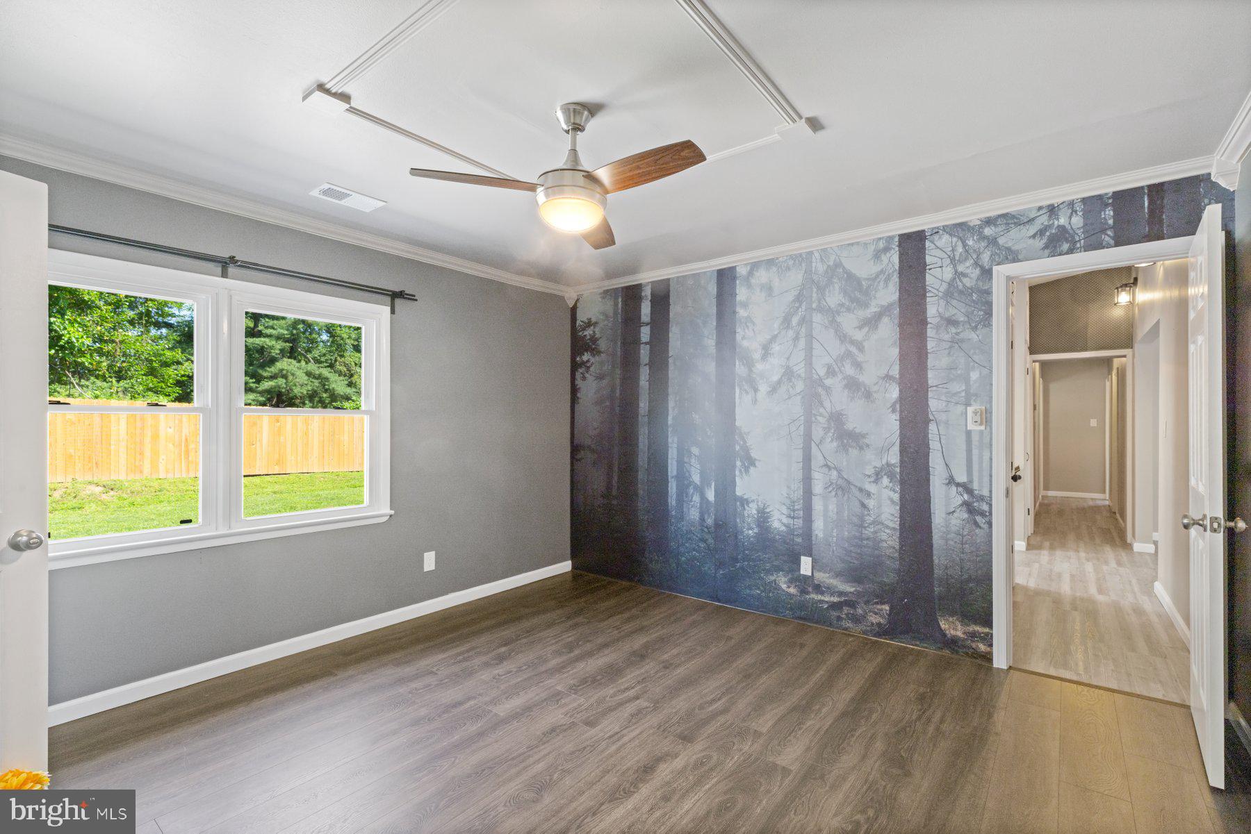 13033 Bottom Road Hydes, MD 21082 - Photo 15 of 45 a view of an empty room with wooden floor and a window
