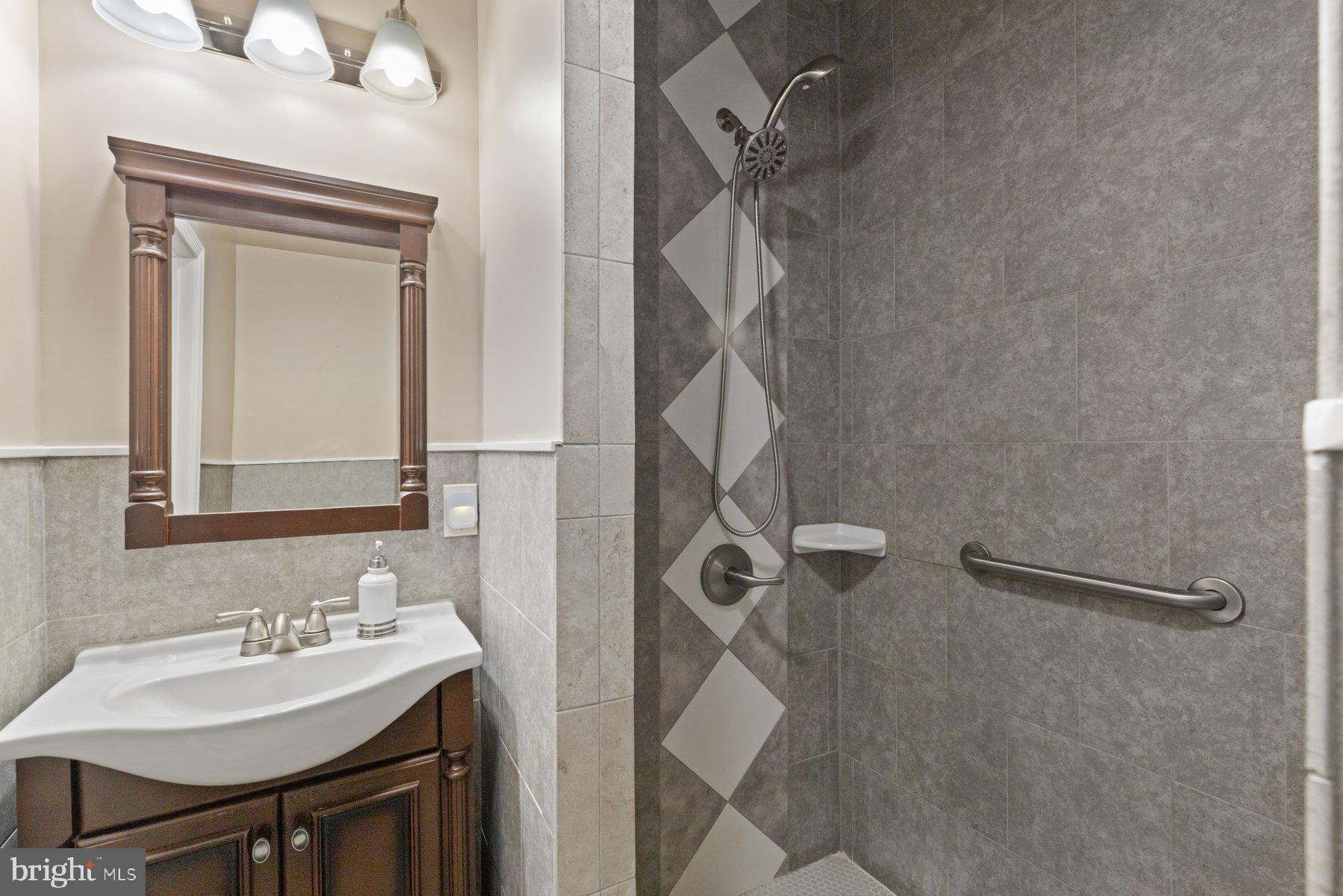 13033 Bottom Road Hydes, MD 21082 - Photo 16 of 45 a bathroom with a sink mirror and shower