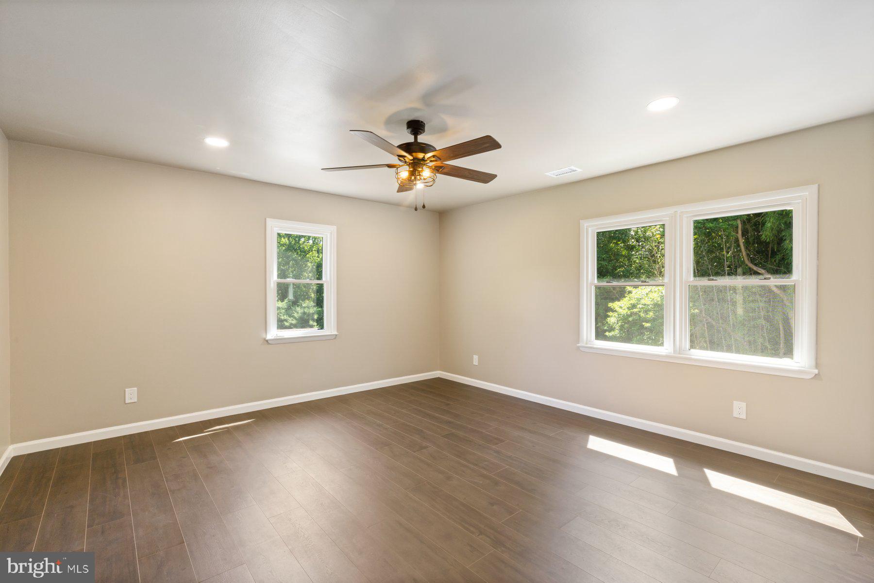 13033 Bottom Road Hydes, MD 21082 - Photo 19 of 45 an empty room with a window and a ceiling fan