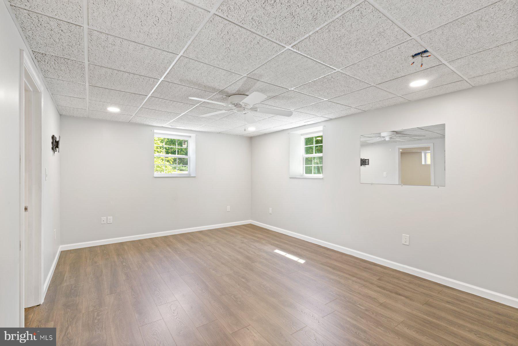 13033 Bottom Road Hydes, MD 21082 - Photo 27 of 45 an empty room with wooden floor and windows