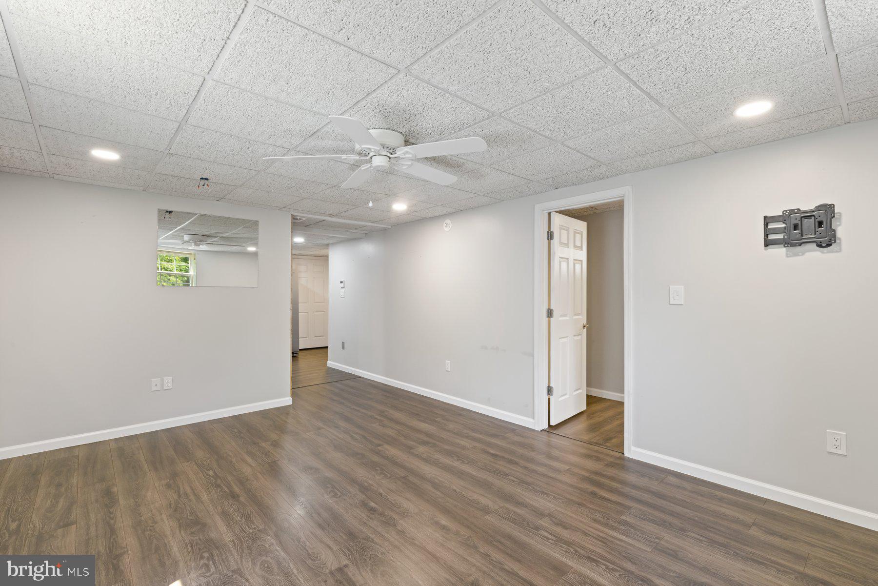13033 Bottom Road Hydes, MD 21082 - Photo 28 of 45 an empty room with wooden floor and windows