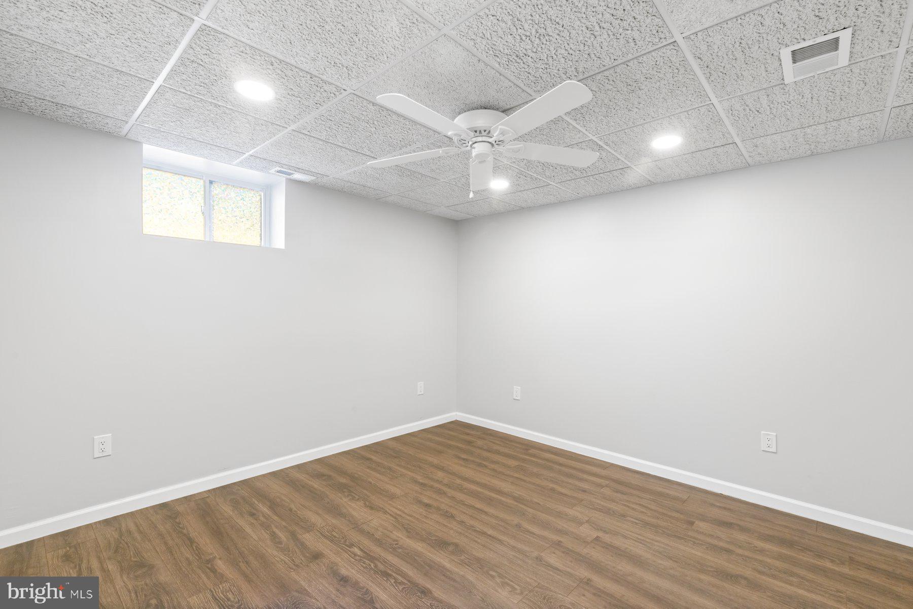 13033 Bottom Road Hydes, MD 21082 - Photo 32 of 45 an empty room with wooden floor and windows