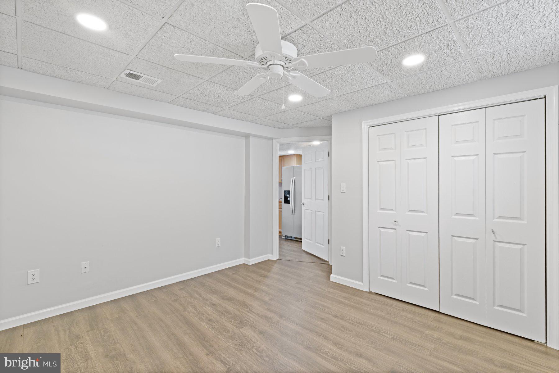 13033 Bottom Road Hydes, MD 21082 - Photo 33 of 45 wooden floor in an empty room with a ceiling fan