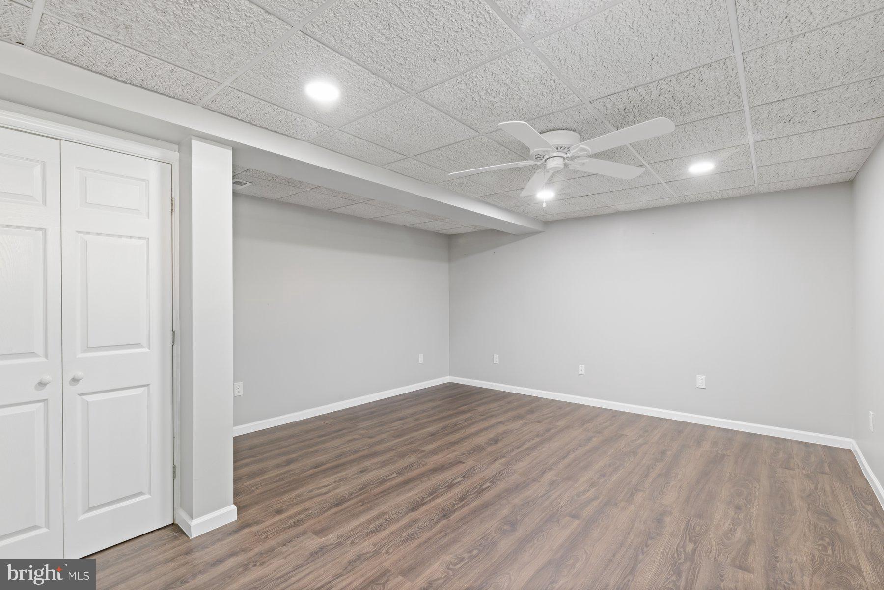 13033 Bottom Road Hydes, MD 21082 - Photo 39 of 45 an empty room with wooden floor and windows
