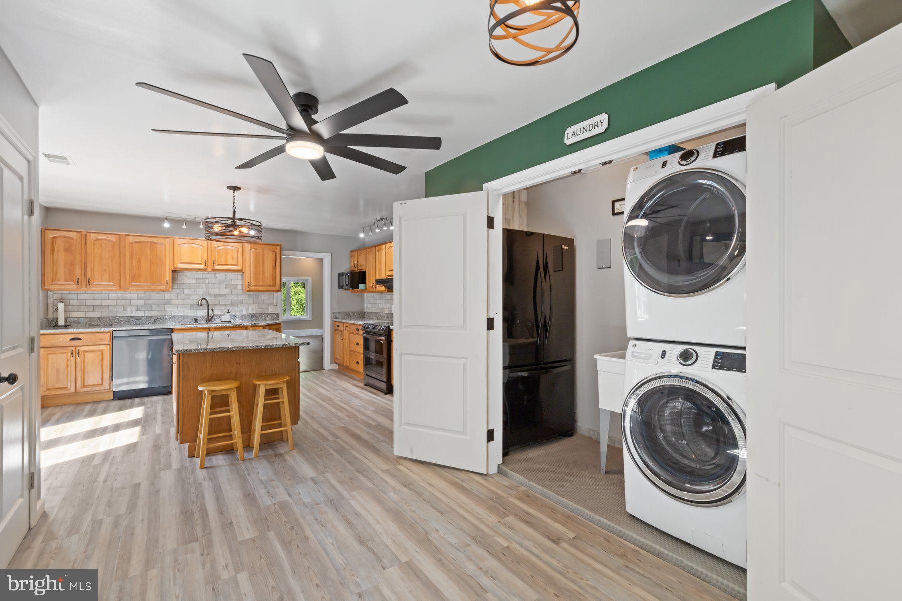 13033 Bottom Road Hydes, MD 21082 - Photo 6 of 45 a view of a kitchen with washing machine and wooden floor