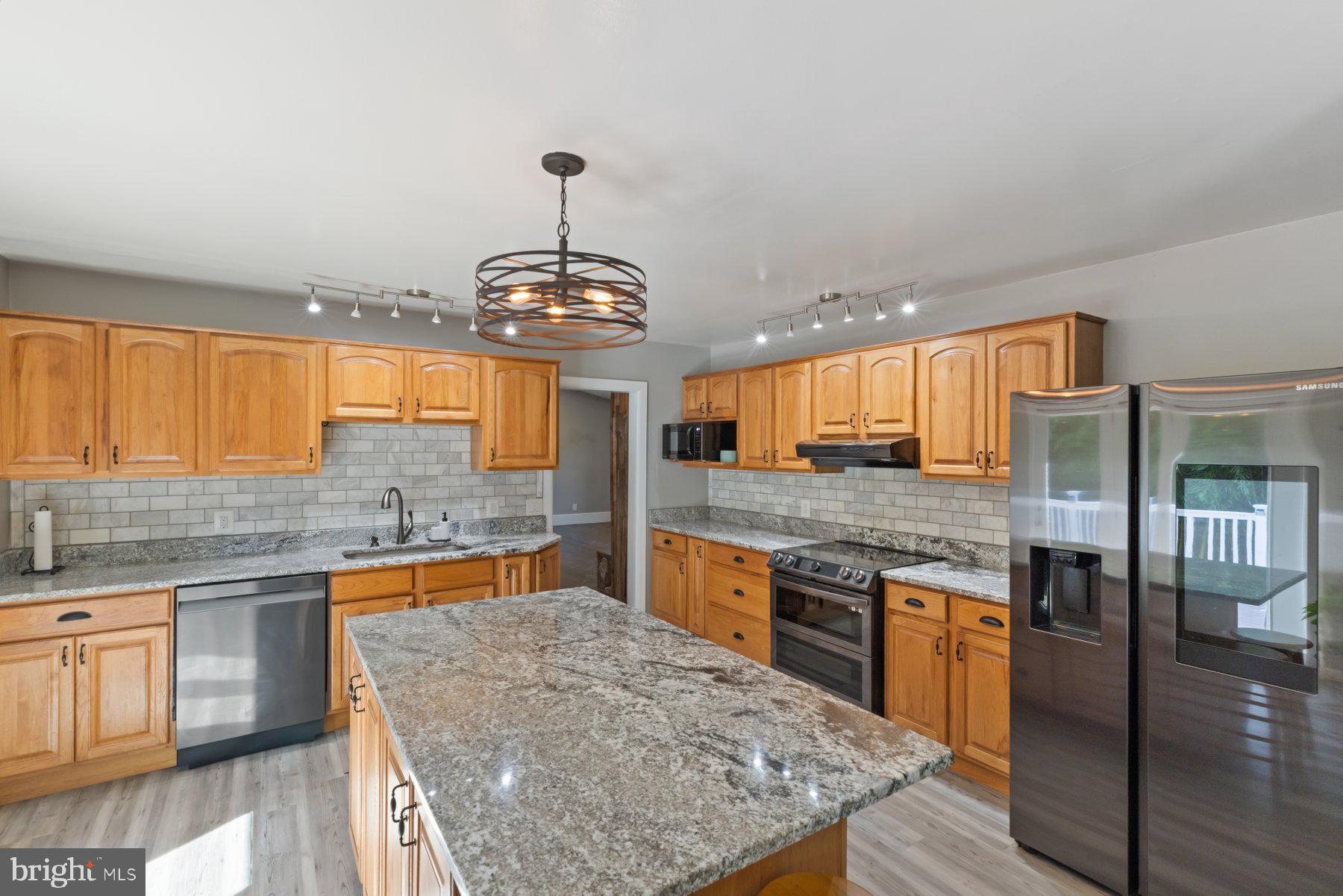 13033 Bottom Road Hydes, MD 21082 - Photo 7 of 45 a kitchen with stainless steel appliances granite countertop a sink stove and refrigerator