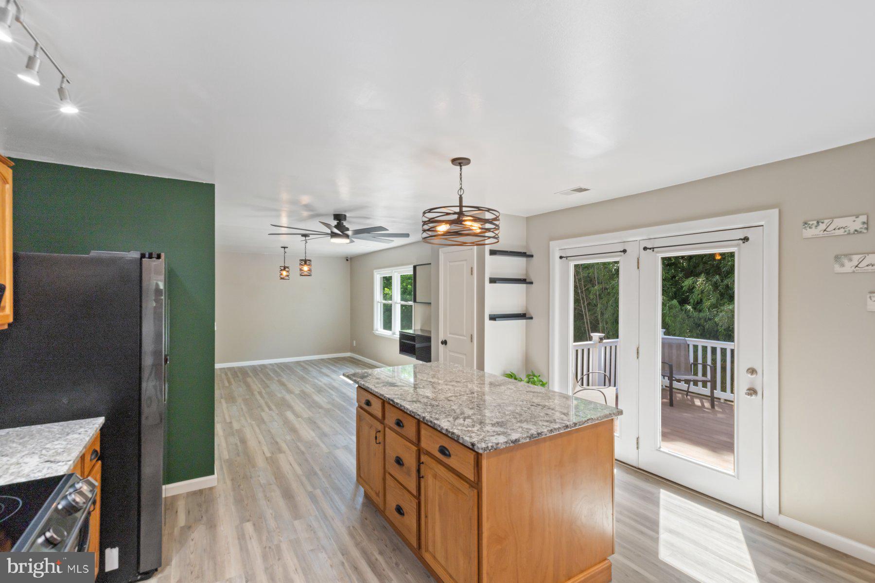 13033 Bottom Road Hydes, MD 21082 - Photo 8 of 45 a kitchen with granite countertop a stove and a wooden floors
