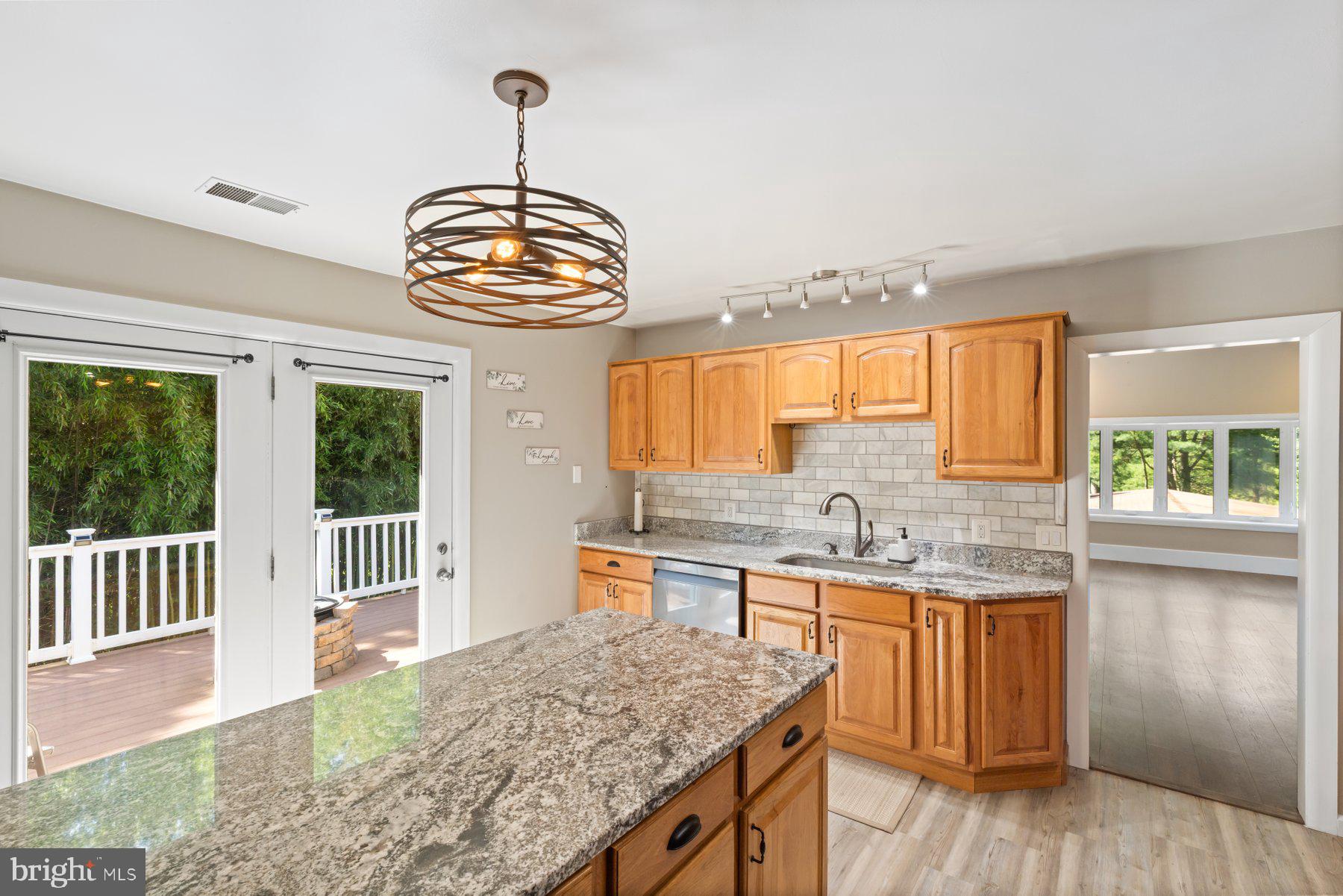 13033 Bottom Road Hydes, MD 21082 - Photo 9 of 45 a kitchen with a stove a sink and wooden cabinets