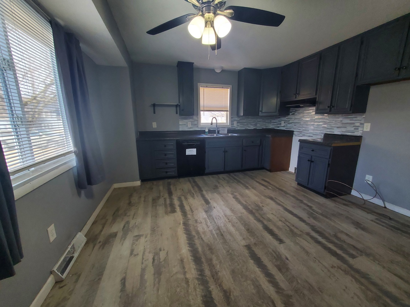 2239 13th Avenue South Clinton, IA 52732 - Photo 5 of 13 a kitchen with stainless steel appliances granite countertop a refrigerator a sink dishwasher a stove and white countertops with wooden floor