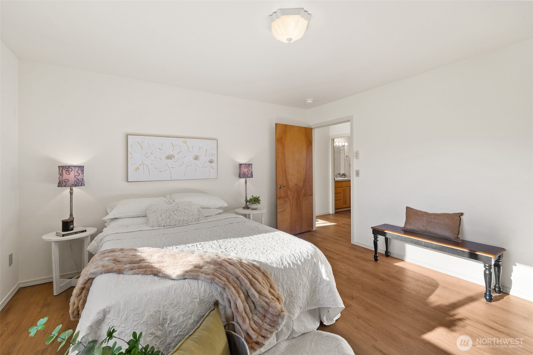 2042 Finn Hall Road Port Angeles, WA 98362 - Photo 22 of 40 a spacious bedroom with a bed and a lamp