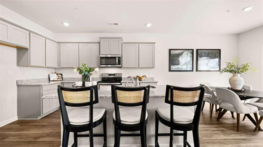 281 Sound Circle Stockbridge, GA 30281 - Photo 11 of 59 a kitchen with a dining table and chairs