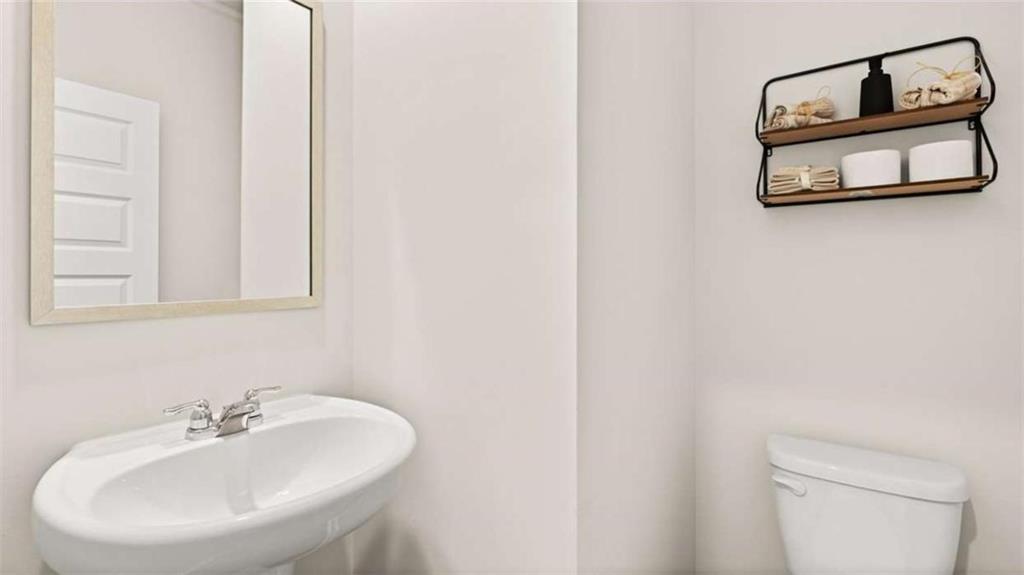 281 Sound Circle Stockbridge, GA 30281 - Photo 29 of 59 a bathroom with a sink and a mirror