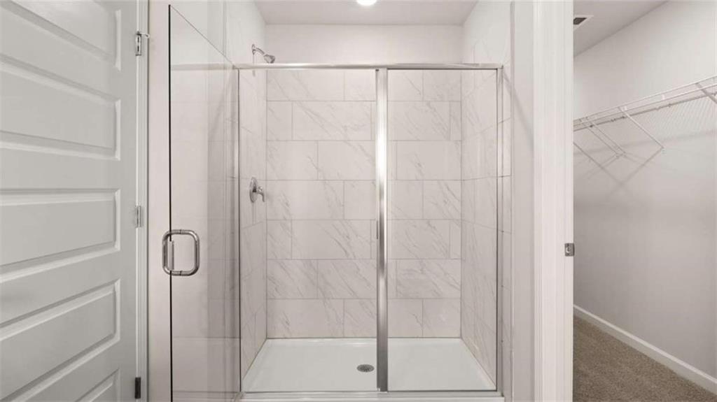 281 Sound Circle Stockbridge, GA 30281 - Photo 40 of 59 a bathroom with a glass shower door