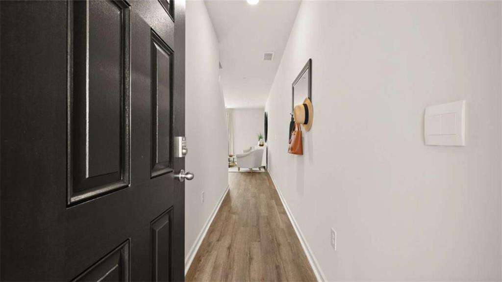 281 Sound Circle Stockbridge, GA 30281 - Photo 7 of 59 a view of a hallway with wooden floor and staircase