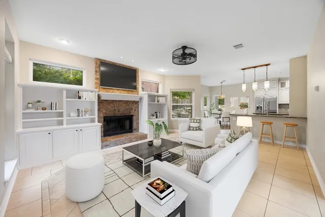 a living room with furniture a flat screen tv and a fireplace