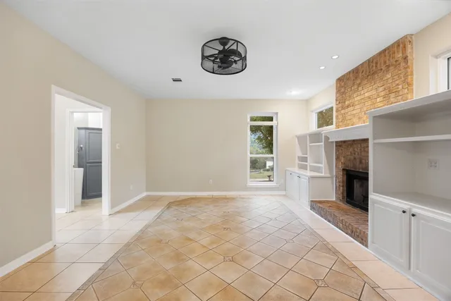 a view of an empty room with a fireplace