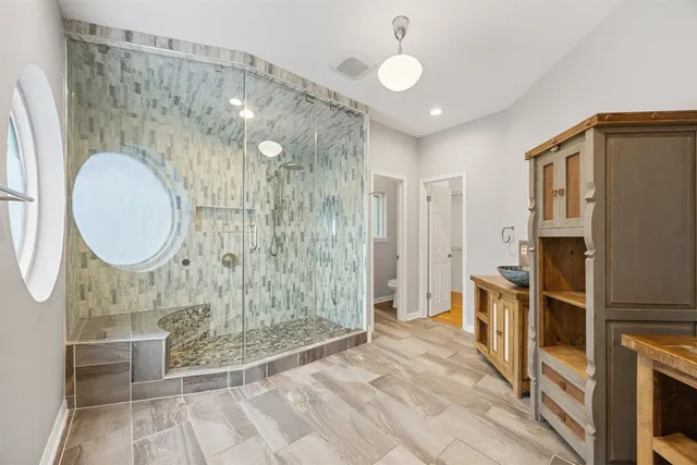 a view of an empty room with window and cabinet