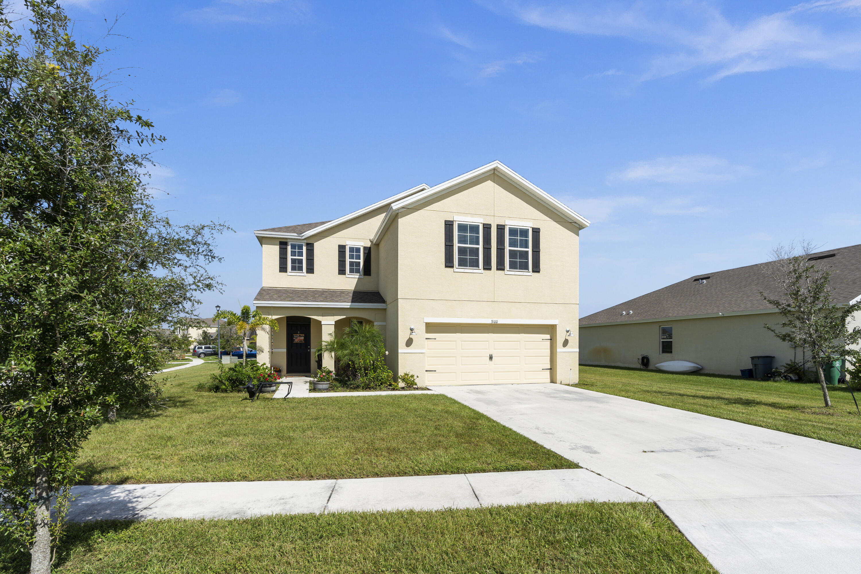 3100 Yellowstone Circle Fort Pierce, FL 34945 - Photo 2 of 28 a front view of a house with a yard