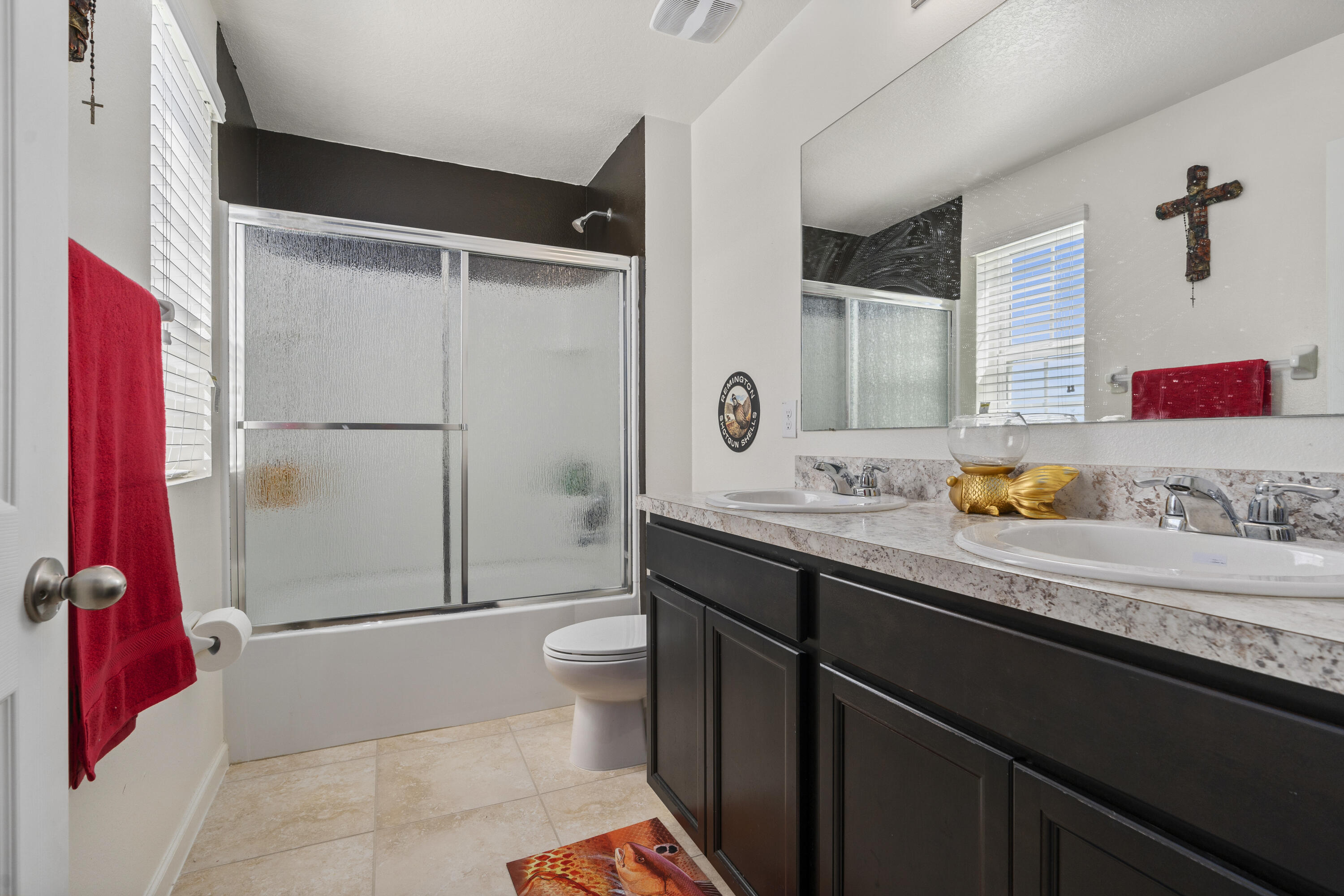 3100 Yellowstone Circle Fort Pierce, FL 34945 - Photo 25 of 28 a bathroom with a granite countertop sink a toilet and a shower