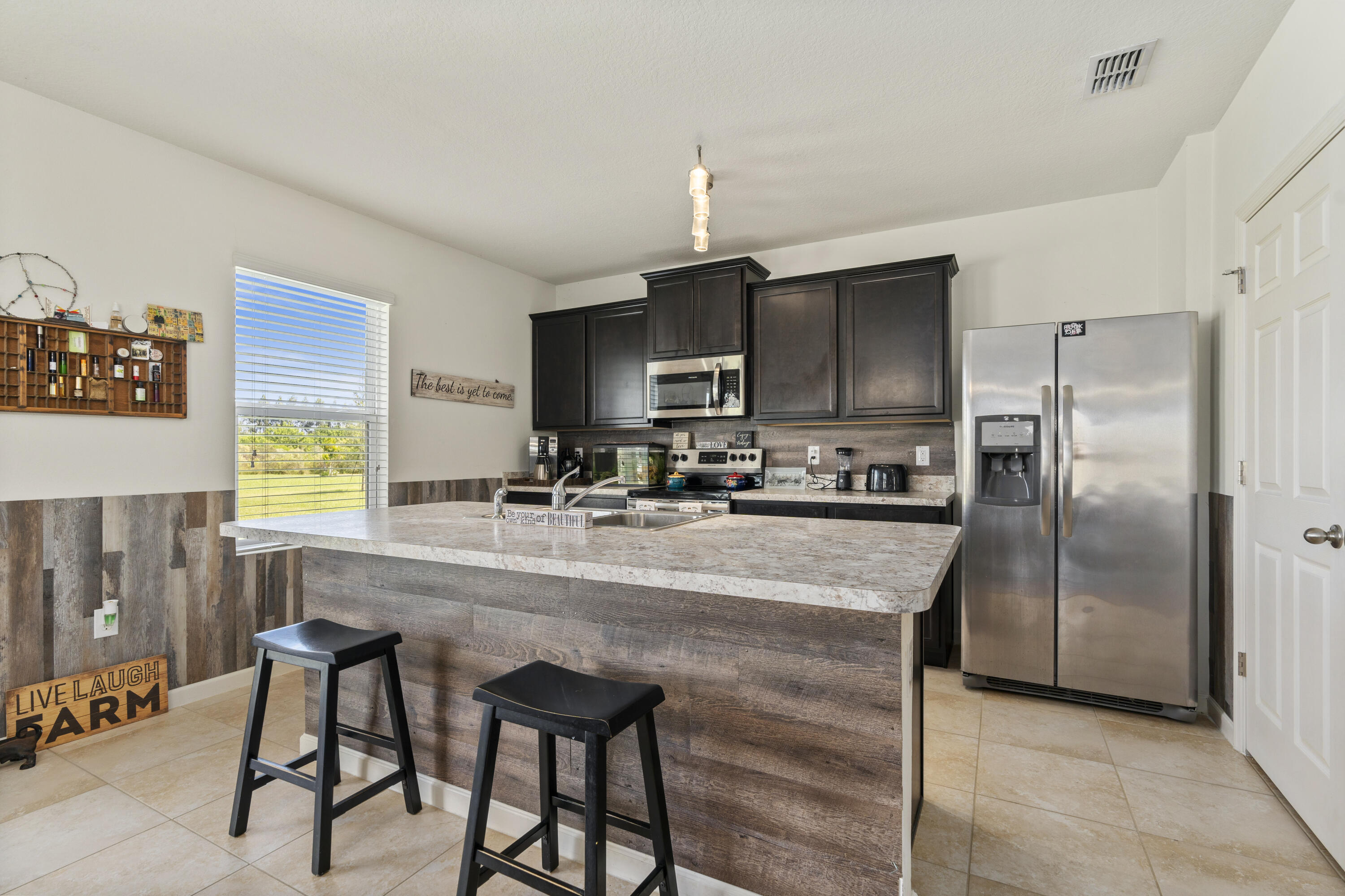 3100 Yellowstone Circle Fort Pierce, FL 34945 - Photo 10 of 28 a kitchen with kitchen island a counter top space appliances and a center island