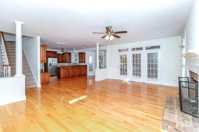 a view of a livingroom with furniture wooden floor and windows