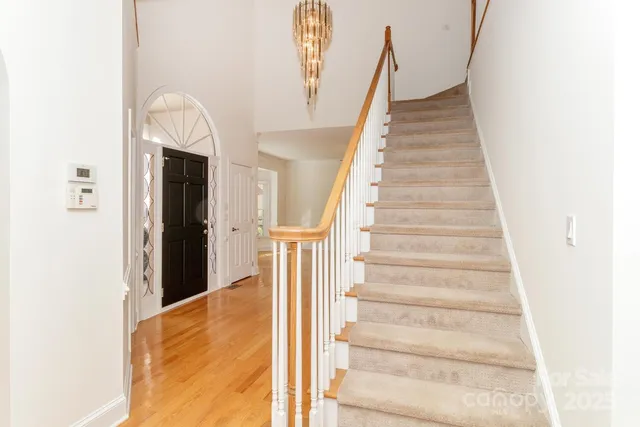 a view of staircase with white walls and windows