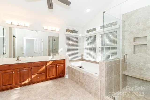 a large bathroom with a tub sink and mirror