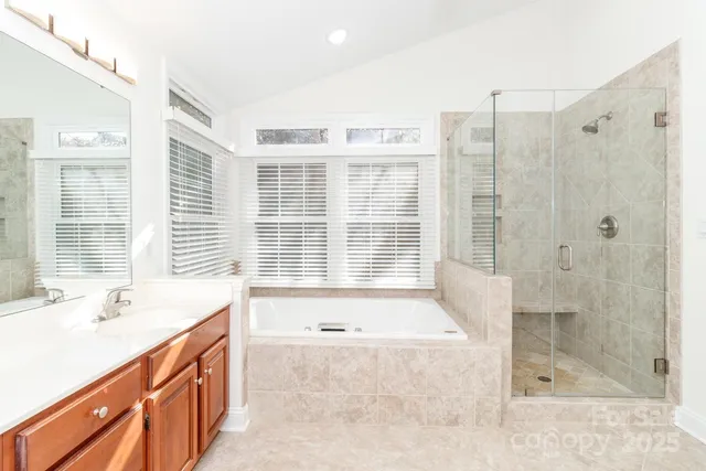 a spacious bathroom with a tub sink and shower