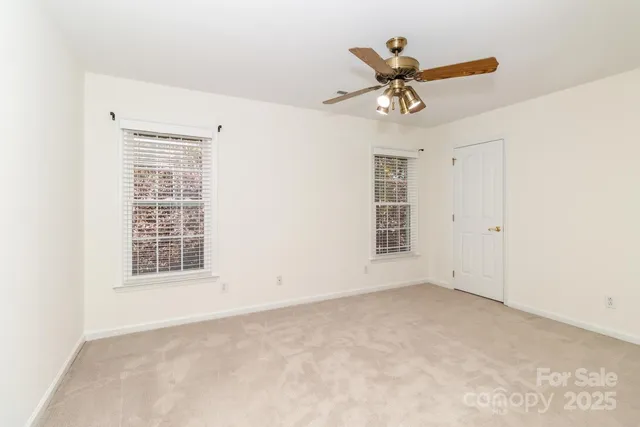 a view of an empty room with a ceiling fan