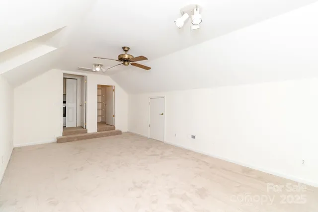 a view of a room with a ceiling fan