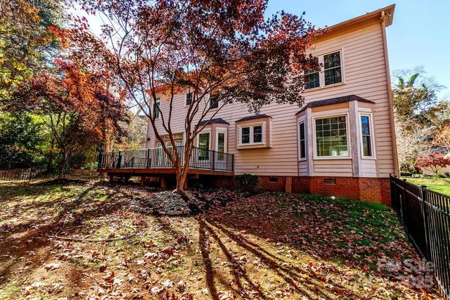 a backyard of a house with lots of green space and trees