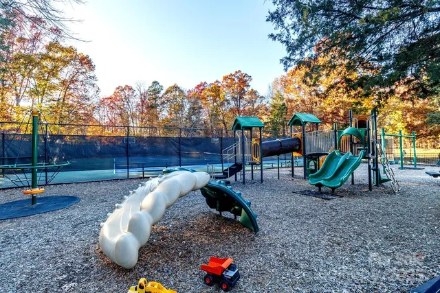 a backyard of a house with barbeque oven table and chairs